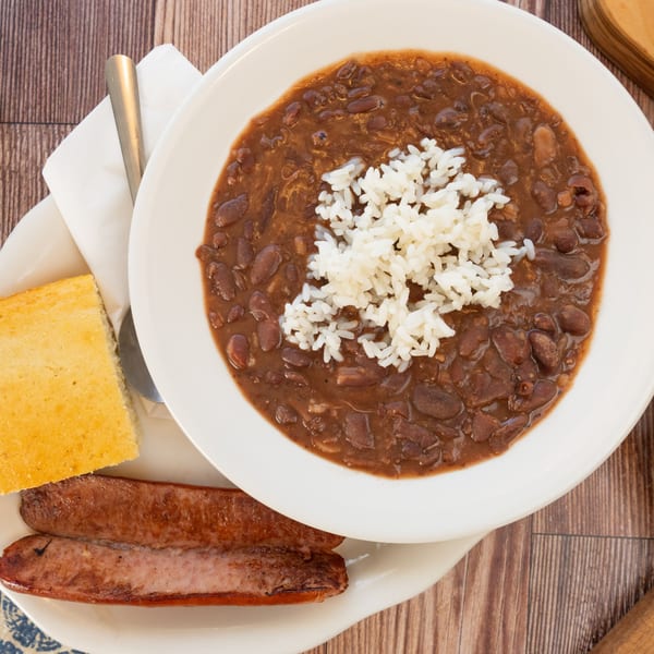 PoFolks' red beans and rice with a side of cornbread and two grilled sausages.