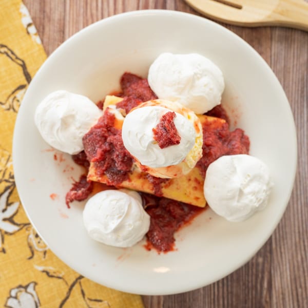 PoFolks' strawberry shortcake dessert with whipped cream and strawberry topping on a white plate.
