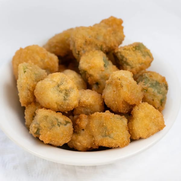 A white bowl filled with golden-brown, breaded fried okra from PoFolks.